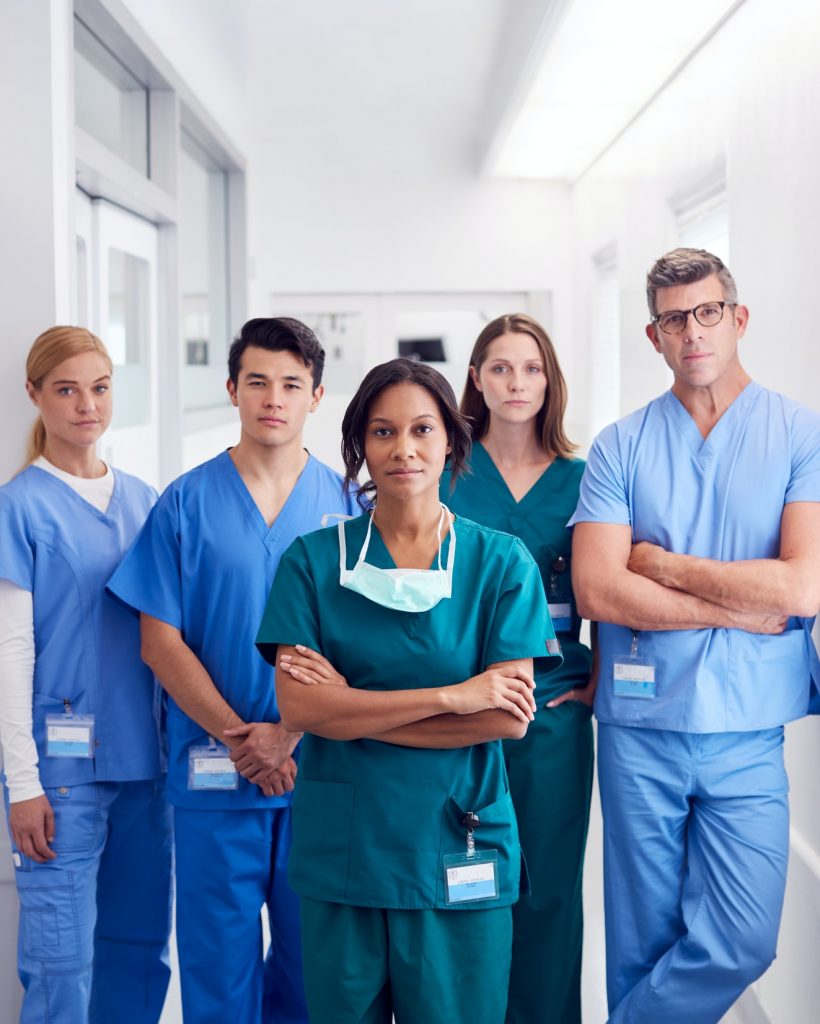 Portrait Of Multi-Cultural Medical Team Standing In Hospital Corridor